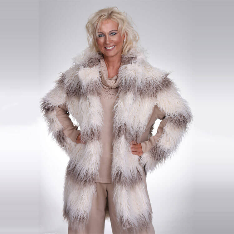 A soft and textured eco fur coat, the knitted side panels of this piece inject easy style and wearability, plus comfort for the colder months. Easily add this piece over any dress or cosy knitted jumper for a truly luxurious look. The eco fur coat with knit side panels is a signature piece for any woman’s wardrobe. When you wear this coat you will make a statement in any room you walk into. The knitted side panels offer up a play on different textures. The front is effortless to open and close. Both the fur and panelling of this coat are coloured in pastel creams and browns so that it can be paired with your staple wardrobe pieces. The piece will work with jeans or smart trousers for an evening look. The eco fur coat is available in sizes small medium and large. Our model wears a size small.