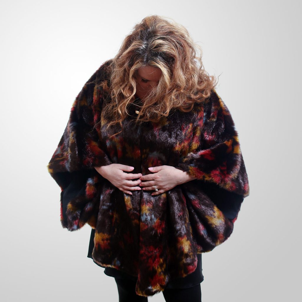 This design is one size fits all and can literally be worn over anything due to its soft non-structured design. The cape features a kimono sleeve and soft flowing drape. Also offered in a multi-shade version.